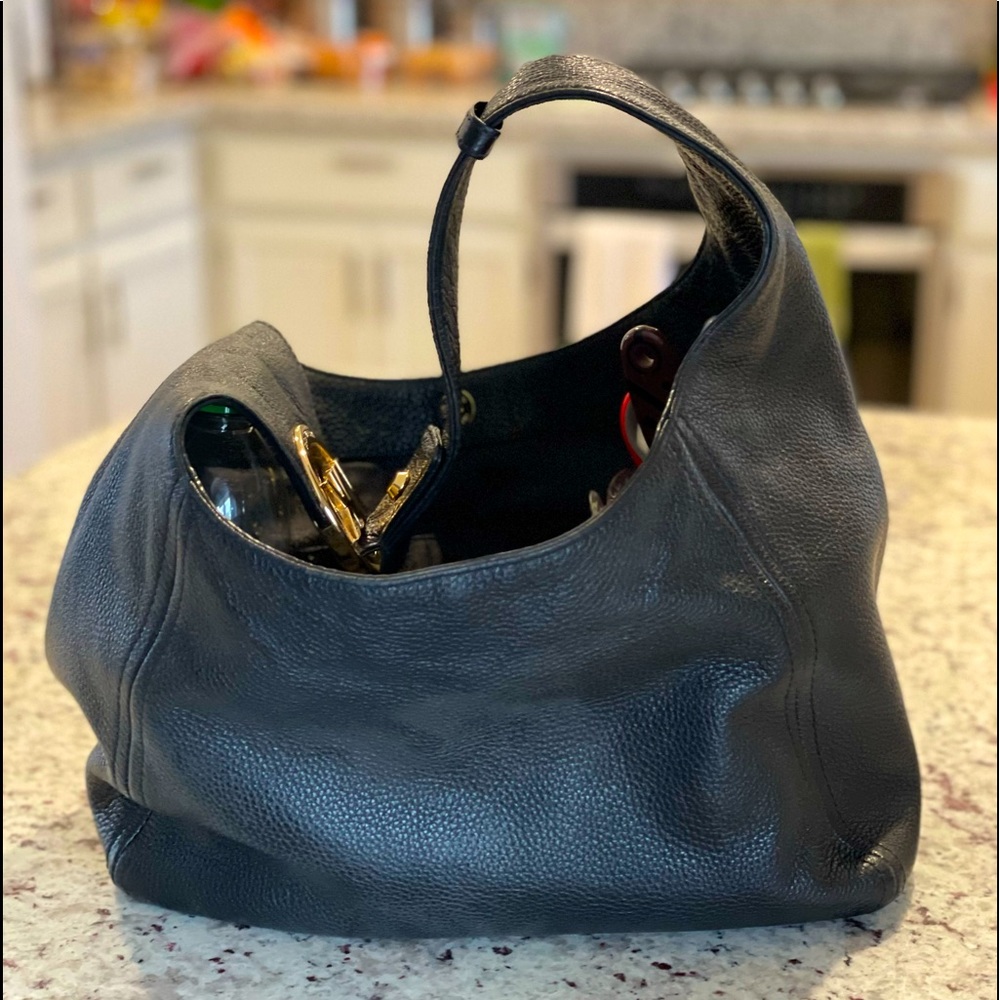 Michael Kors soft leather, black, large hobo style purse gold detail.